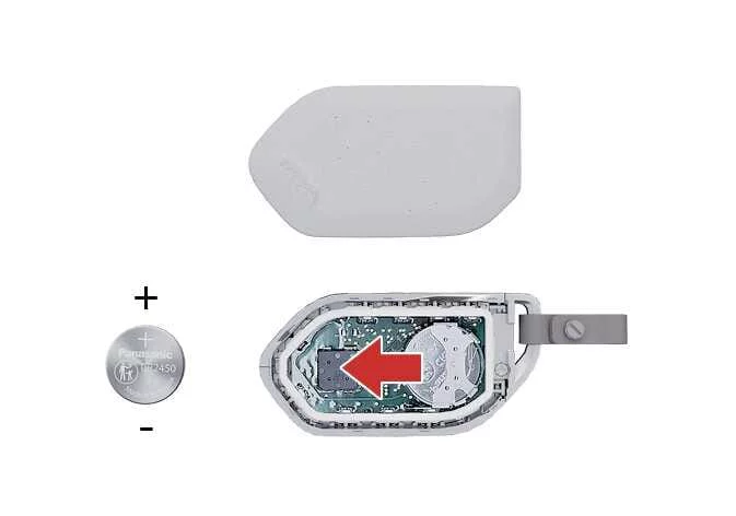 Removing the old CR2450 coin cell battery from the Kia Sorento key fob housing