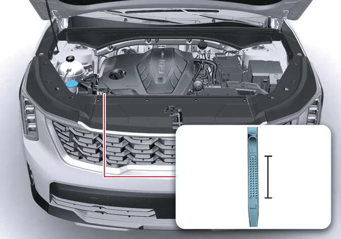 Technician checking the engine oil dipstick on a Kia Sorento