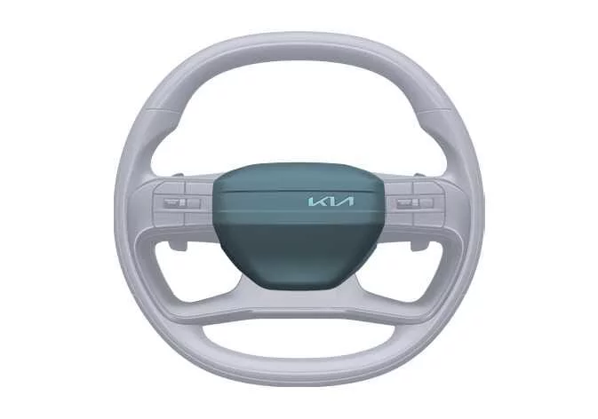 Central horn activation pad located on the steering wheel of a Kia Sorento