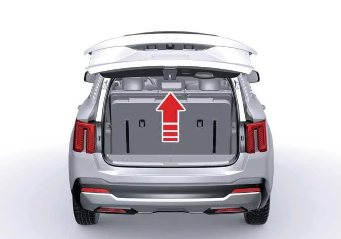 Pressing the exterior release handle under the Kia Sorento rear liftgate emblem