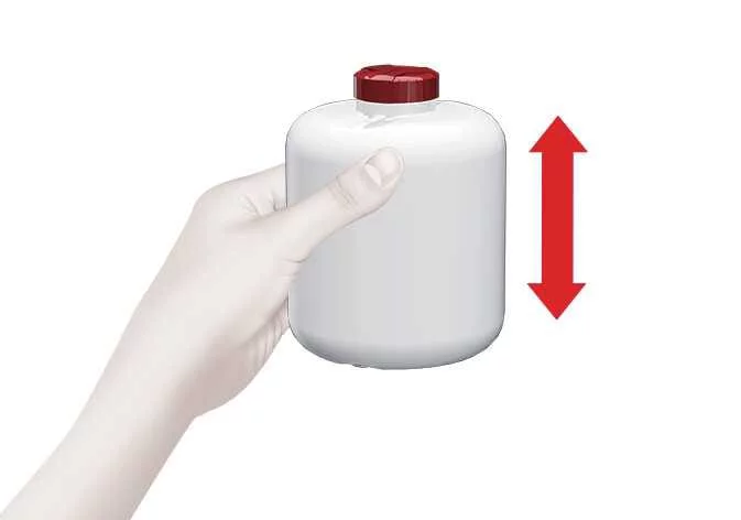 Shaking the sealant bottle prior to use in the Kia Sorento Tire Mobility Kit procedure