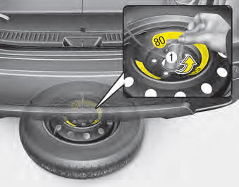 5.After the spare tire reaches the ground, continue to turn the wrench counterclockwise,